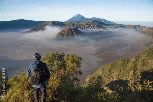 A man traveller looking for a view around lawang village at Mountain BROMO 