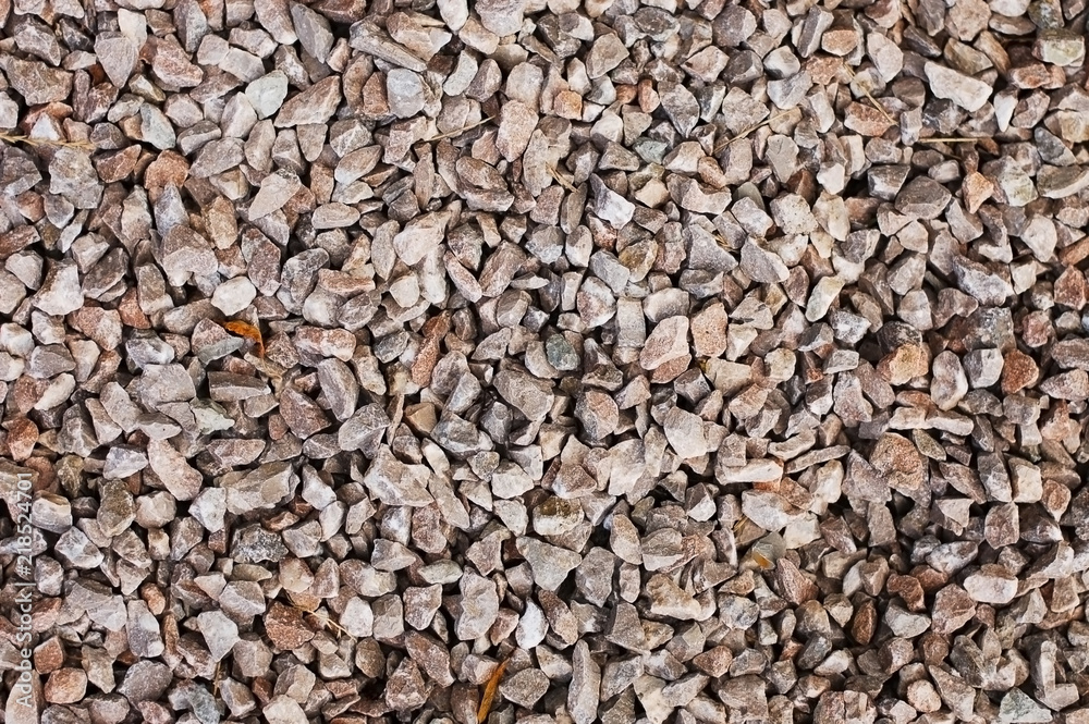 A background of small brown pebbles for landscape design and sprinkle of lawns A background of small brown pebbles for landscape design and sprinkle of lawns