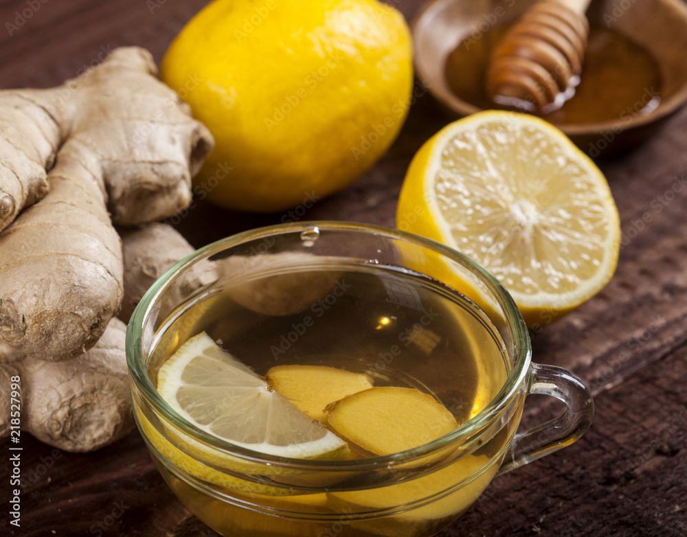 Ginger tea with lemon on wooden background Ginger tea with lemon on wooden background