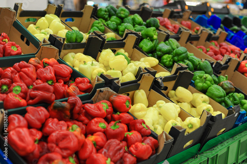 Red, yellow, green bell pepper on the counter in the supermarket