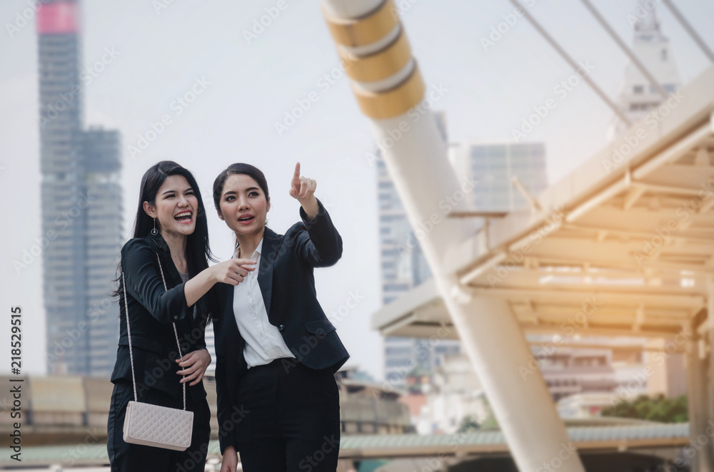 smiling business woman holding mobile phone and talking with partner while standing in modern city, professional employees, successful, support, partner, teamwork, community and connection concept smiling business woman holding mobile phone and talking with partner while standing in modern city, professional employees, successful, support, partner, teamwork, community and connection concept