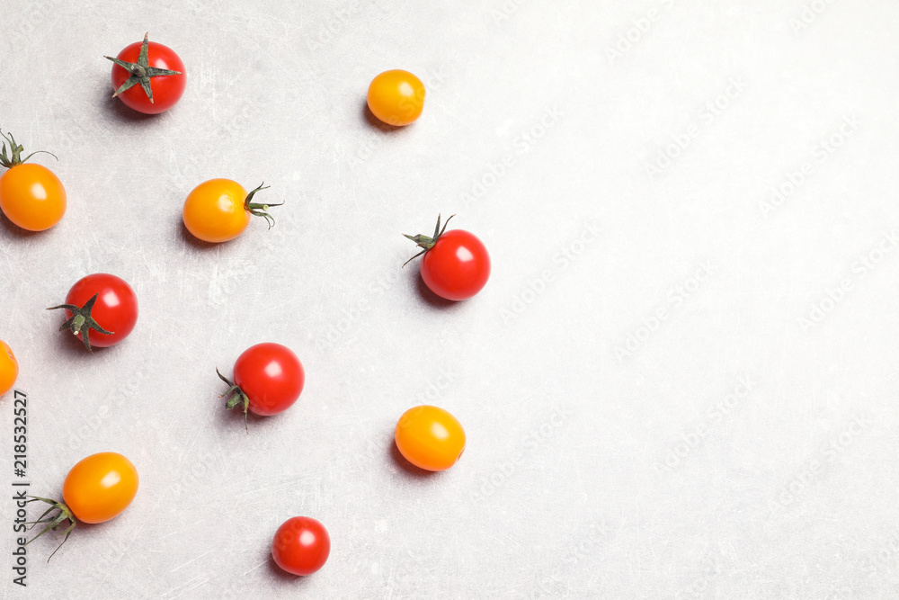 Flat lay composition with juicy tomatoes on grey background