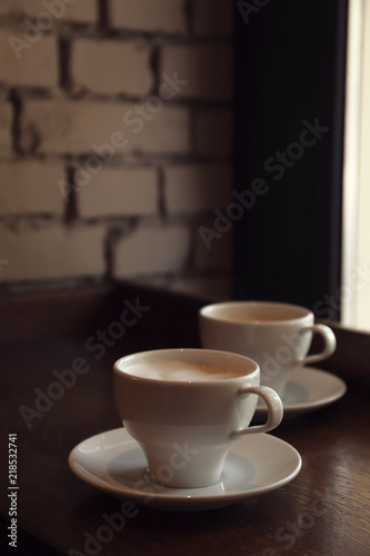 Fototapeta Naklejka Na Ścianę i Meble -  Cups of fresh aromatic coffee on table