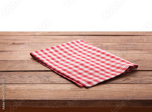 Red checkered tablecloth on wooden table. Napkin close up top view mock up