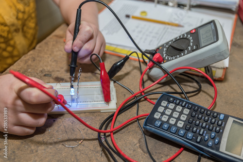 Electrician works with voltage tester - close-up