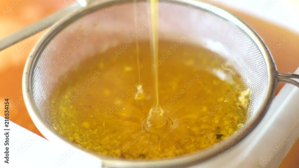 Closeup of honey trickle filling plate full of honey Closeup of honey trickle filling plate full of honey