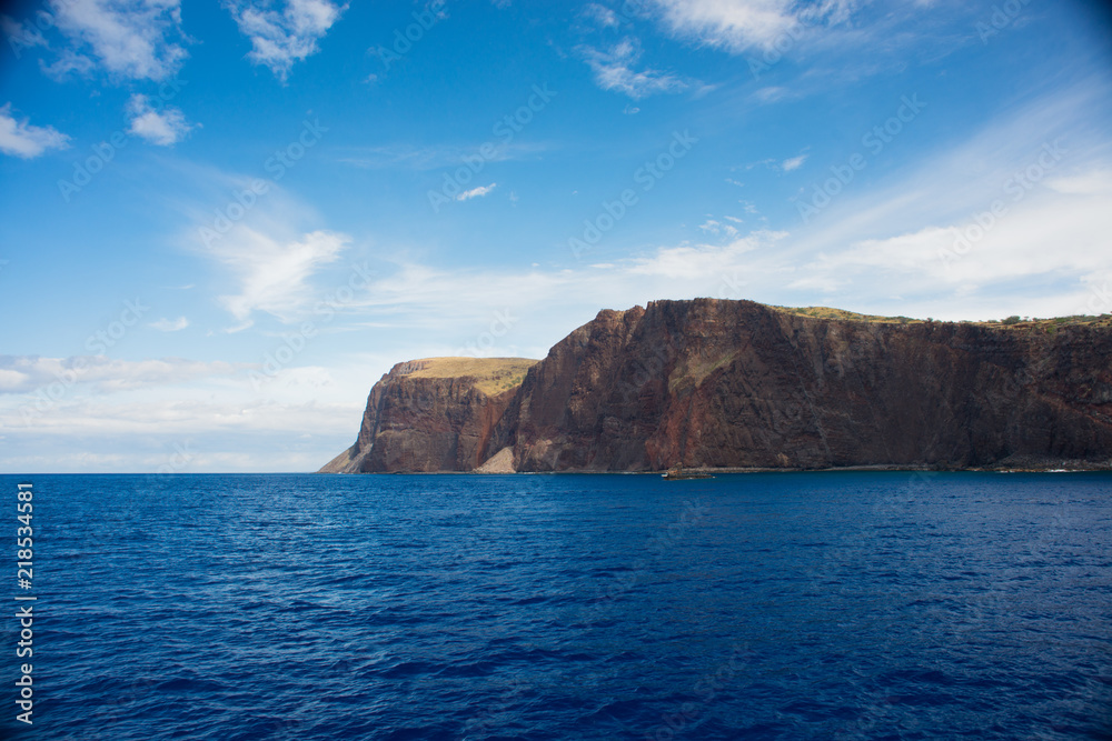 Cliffs on the island of Lanai, Hawaii, as seen from a boat on a clear sunny day
