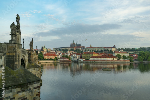View of the panorama of the old historic center of Prague by the river and the Charles Bridge in the early morning