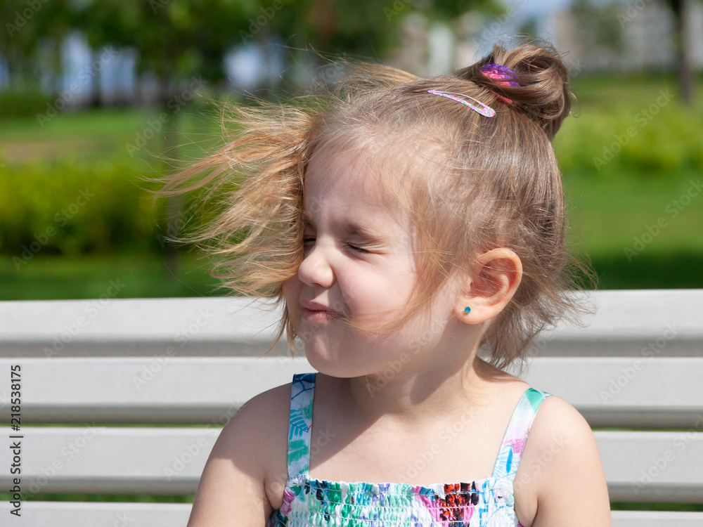 portrait of the young girl with the hair fluttering from wind portrait of the young girl with the hair fluttering from wind