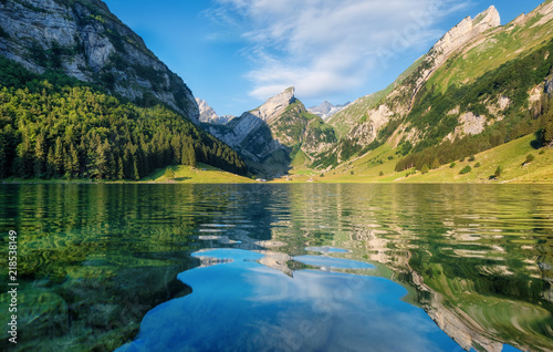 Fototapeta Naklejka Na Ścianę i Meble -  Mountains and lake in the Switzerland. Reflection on the water surface. Natural landscape in the Switzerland at the summer time. Lake and wave