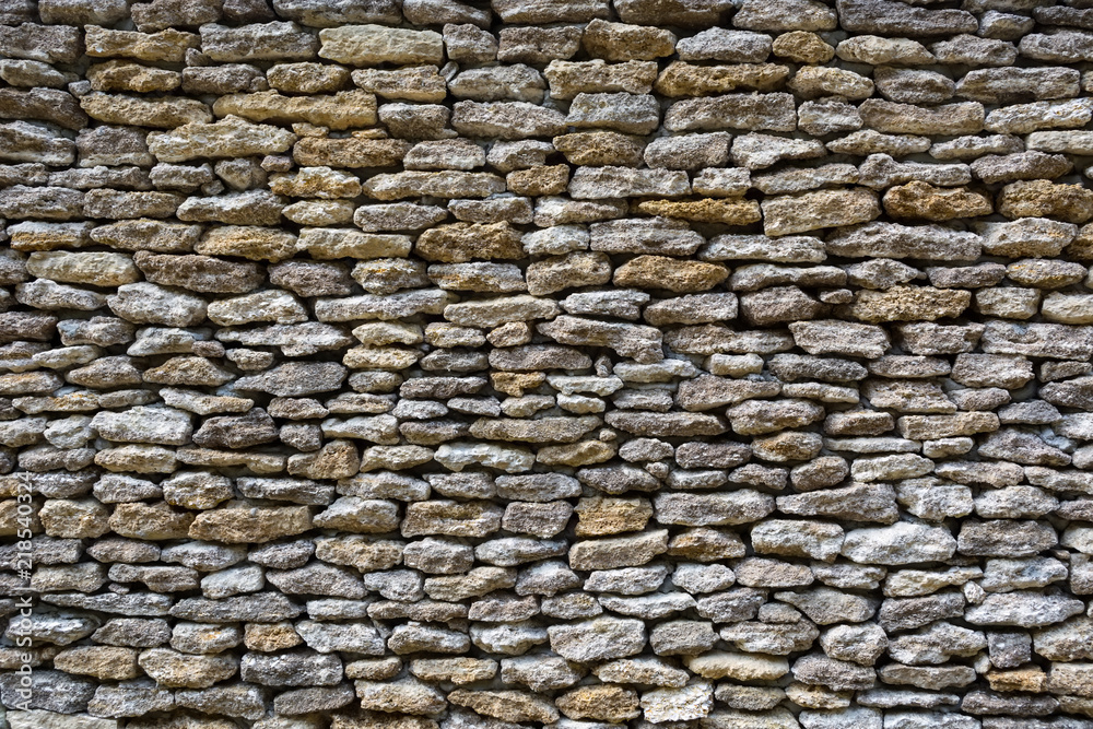 Fototapeta premium background of limestone walls, densely piled stones