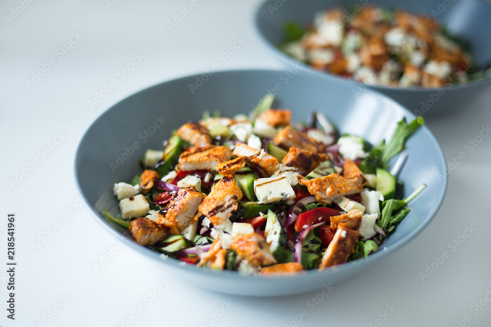 A healthy chicken salad in a grey bowl. A healthy chicken salad in a grey bowl.