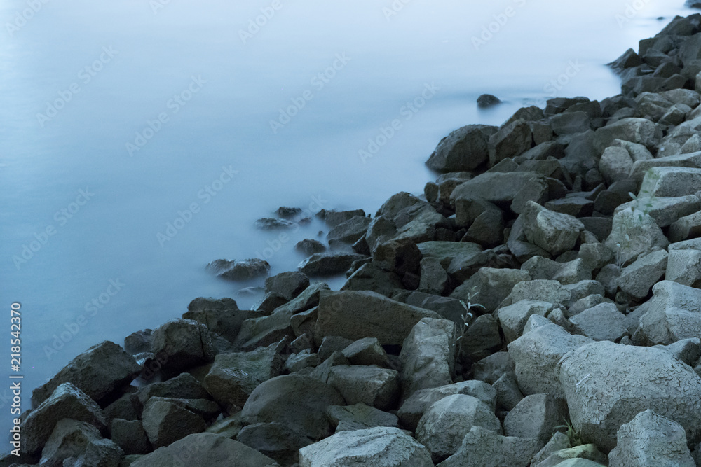 Long exposure of stones at water at river side Long exposure of stones at water at river side