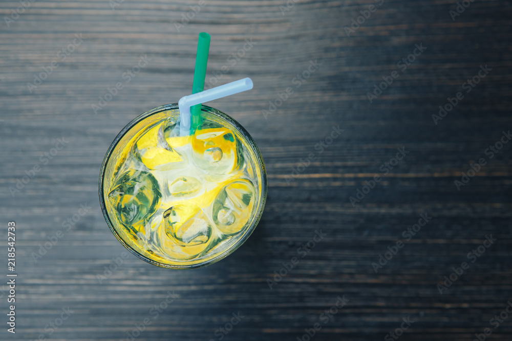 Lemonade with ice. Background wooden table. top view Lemonade with ice. Background wooden table. top view