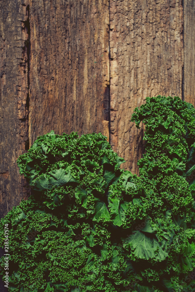 fresh kale on rustic wooden surface
