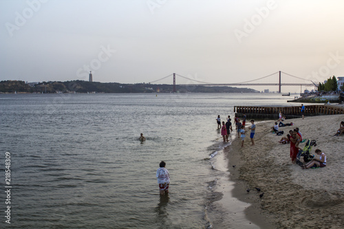 LISBON, PORTUGAL - August, CIRCA 2018: People are cooling at tagus river on one of the hottest summer days in Portugal photo