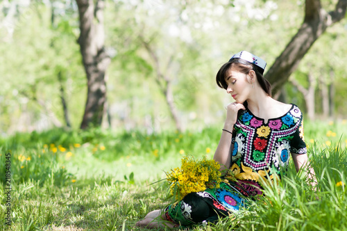 Girl, woman in national historic Tajik costume. Central Asia photo