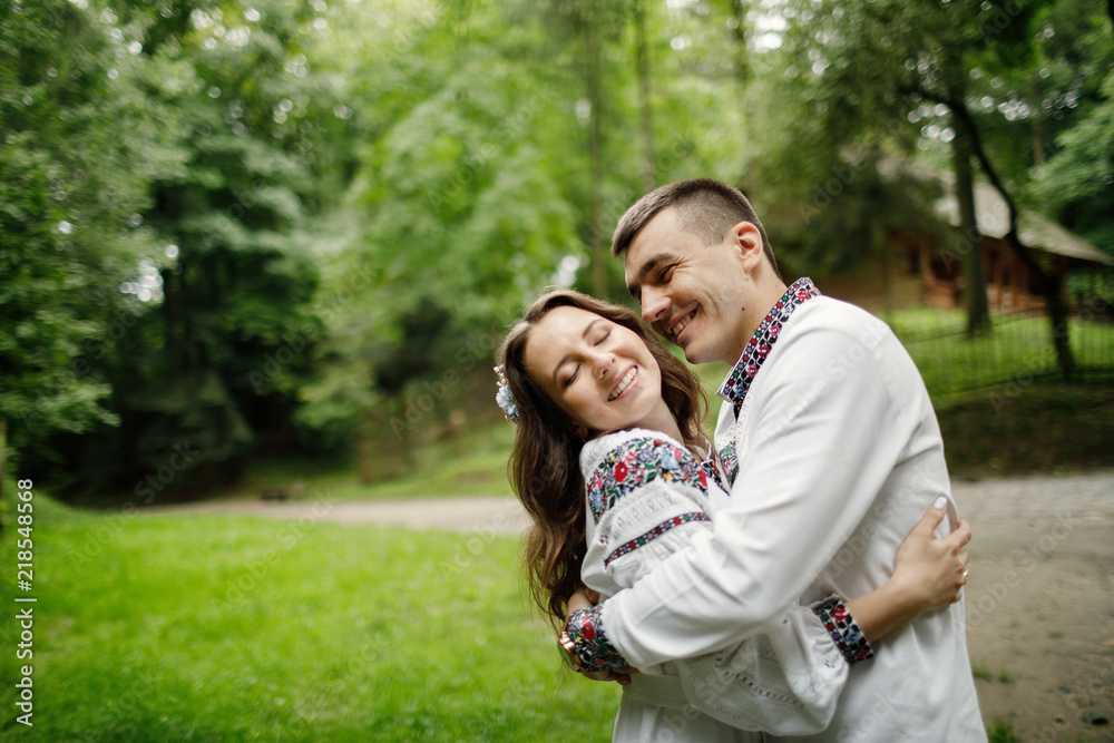 Beautiful bride and groom in the ukrainian style are standing w Beautiful bride and groom in the ukrainian style are standing w