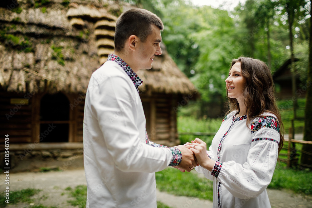 Beautiful bride and groom in the ukrainian style are standing w Beautiful bride and groom in the ukrainian style are standing w
