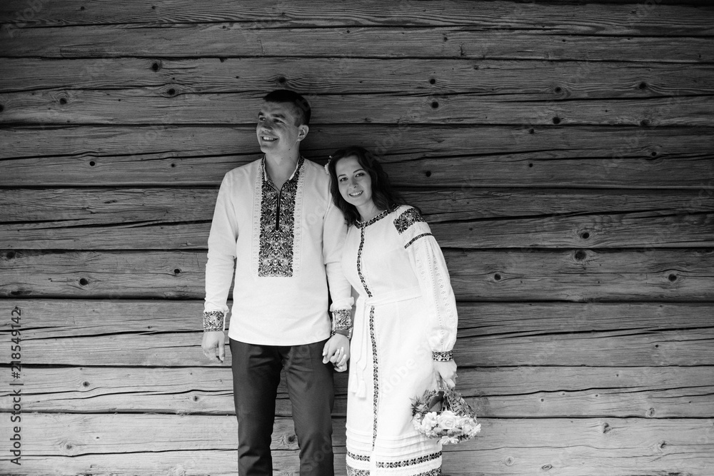 Beautiful bride and groom in the ukrainian style are standing w Beautiful bride and groom in the ukrainian style are standing w