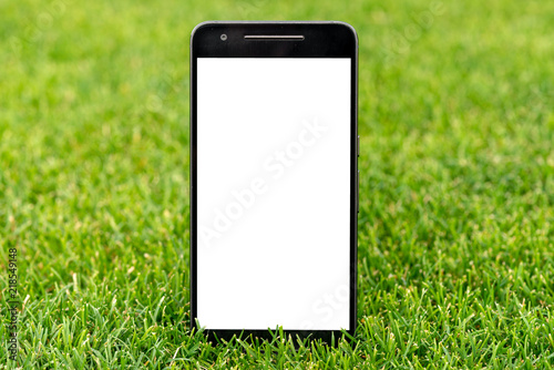 Mobile smart phone mockup with white screen on green grass background. Highly detailed illustration.