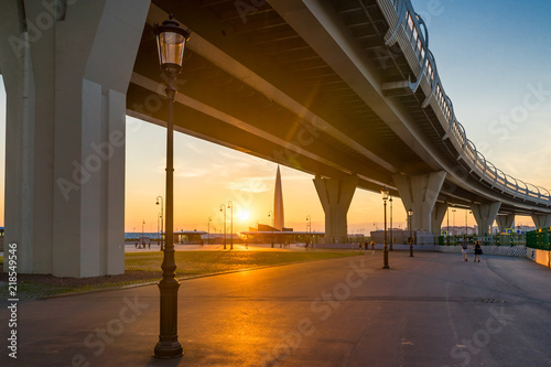 Western Speed Diameter, Lakhta Center and the sun at sunset in St. Petersburg in the summer. Russia