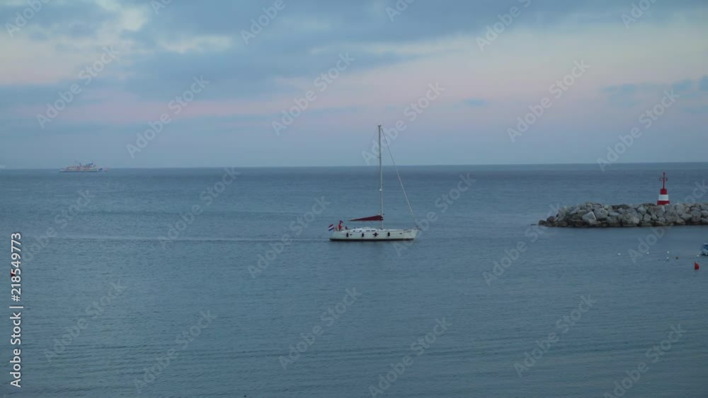 Piombino, Livorno, Tuscany, Italy - June 17, 2018. Yacht going to the harbour in the evening Piombino, Livorno, Tuscany, Italy - June 17, 2018. Yacht going to the harbour in the evening