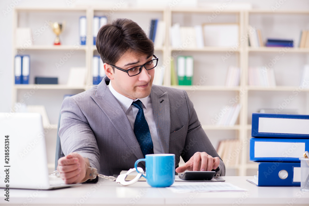 Businessman chained with handcuffs to his coffee
