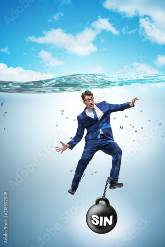Businessman drowning under the burden of sin and guilt