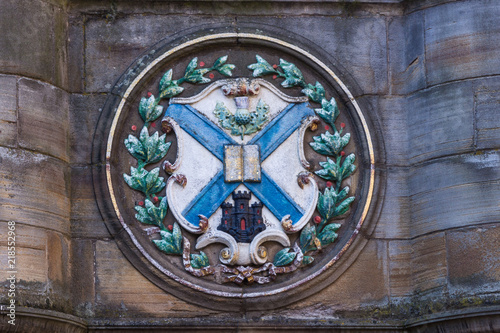 Edinburgh, Scotland, UK - June 13, 2012; Closeup of plate set on Metcat Cross near St. Giles Cathedral, featuring emblem with Scottish flag and castle symbol. photo