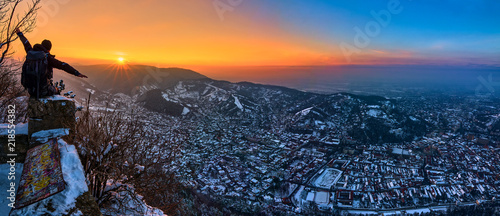 A panoramic view of the city Brasov at sunset above the Mount Tampa in the winter time photo