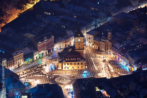 Brasov, Transylvania. Romania. Panoramic view of the old town and  Council Square, Aerial twilight cityscape of Brasov city, Romania photo