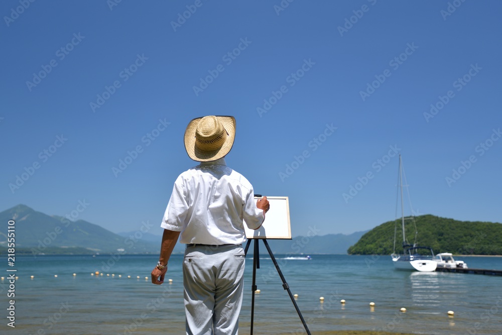 夏の湖畔・のんびりと絵を描く男性 