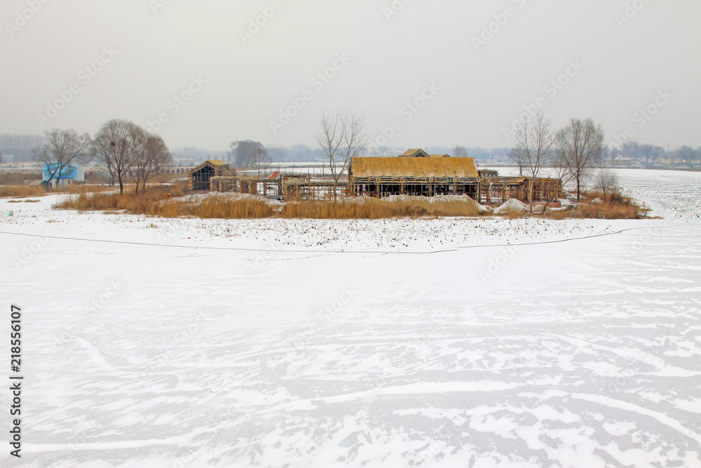 unfinished building on the frozen river