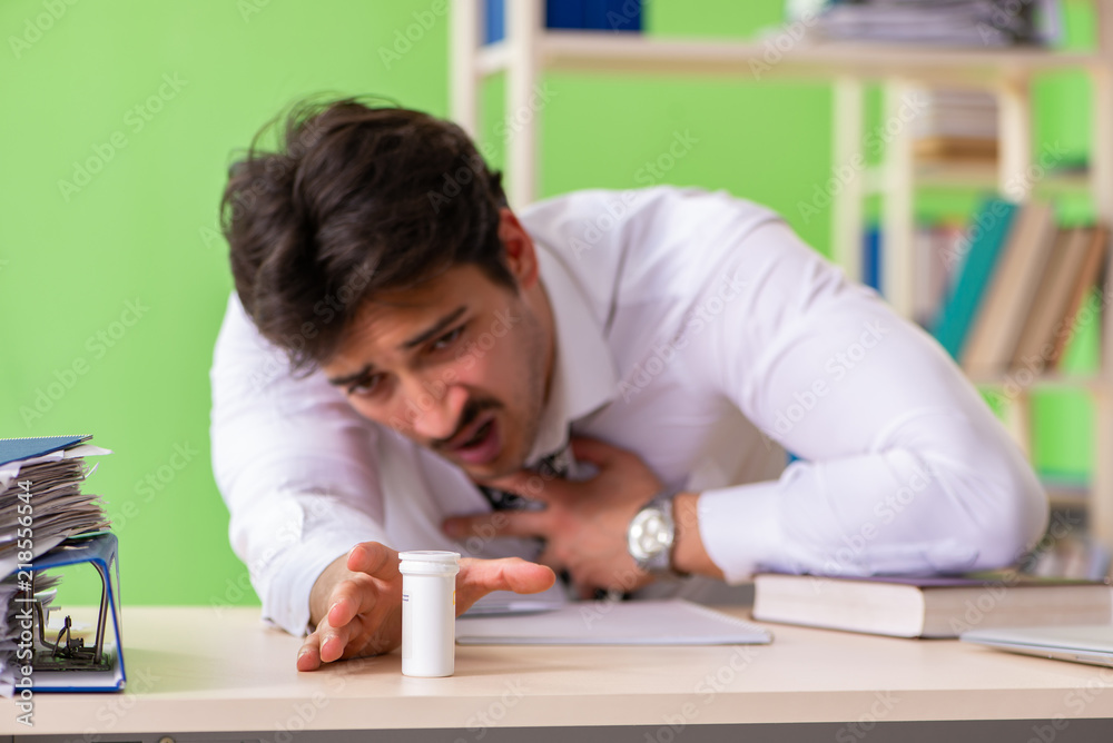 Sick and unhappy businessman sitting in the office Sick and unhappy businessman sitting in the office