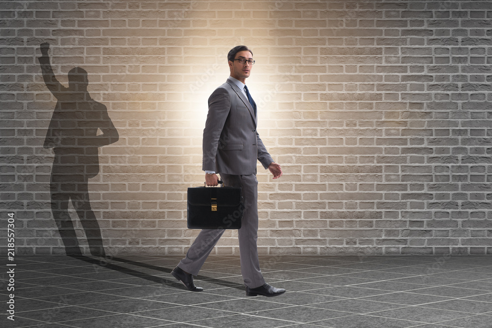 Businessman and his shadow in business concept Businessman and his shadow in business concept