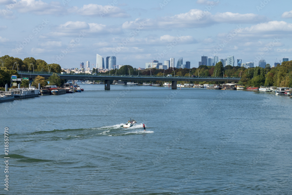 Water skiing on the Seine between Saint-Cloud and Boulogne Billancourt with  La Défense in the background 01 Stock Photo | Adobe Stock