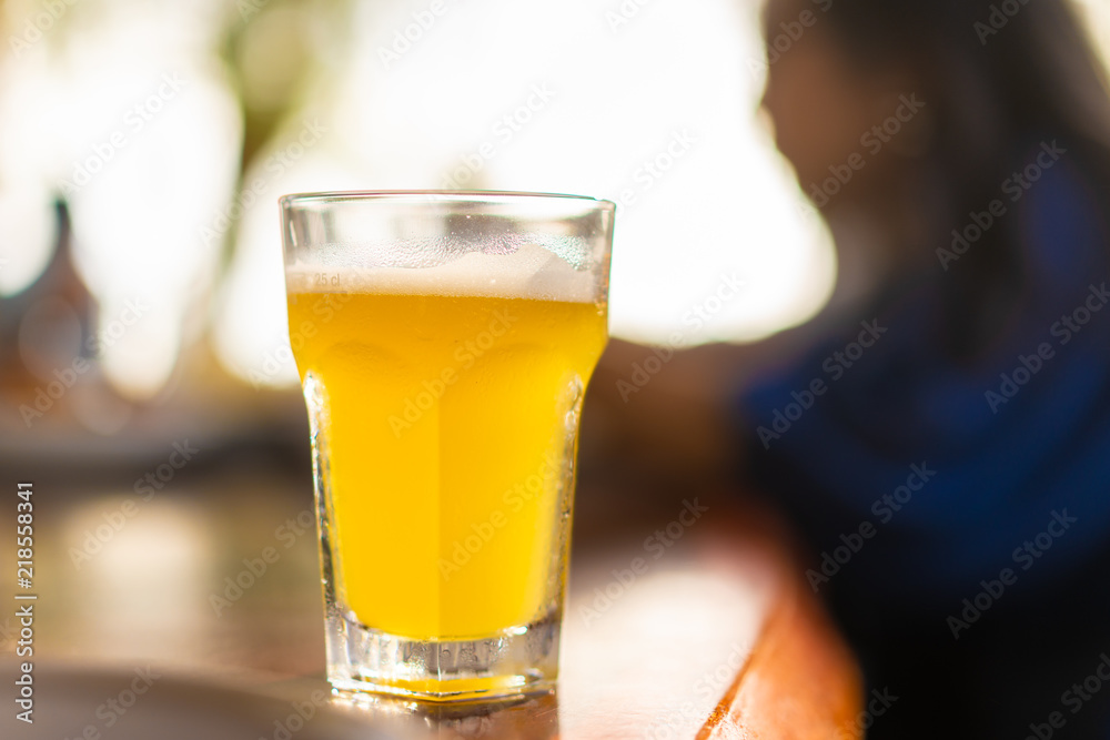 Glass of beer on restaurant table with blurred enjoy people eating background Glass of beer on restaurant table with blurred enjoy people eating background