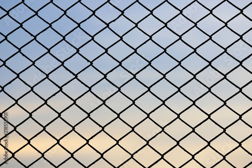 Steel mesh fence with beautiful sky background