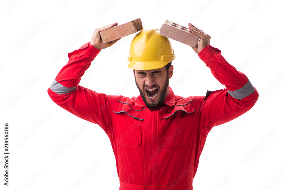 Angry builder breaking bricks isolated on white