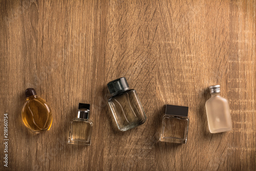 Set of perfume bottles on wooden table background. photo