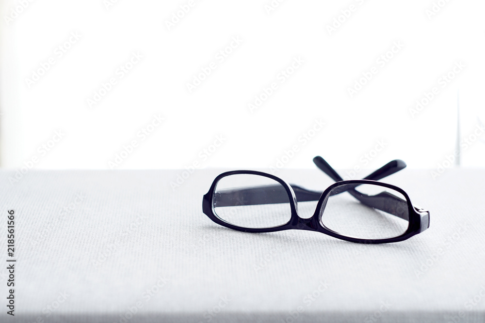 A spectacle over white curtain background A spectacle over white curtain background