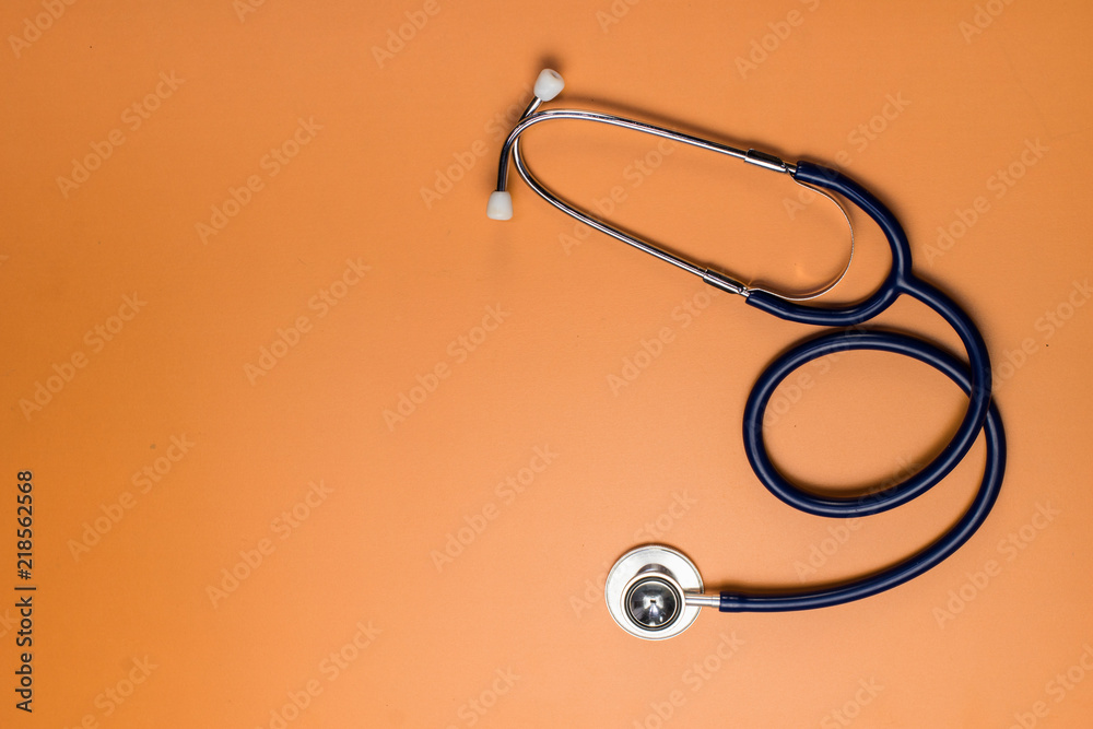 stethoscope medical on orange background copy space