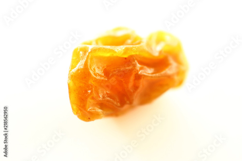 Close up raisin texture as background / A raisin is a dried grape. Raisins are produced in many regions of the world and may be eaten raw or used in cooking, baking, and brewing