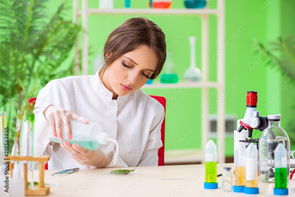 Beautiful female biotechnology scientist chemist working in lab
