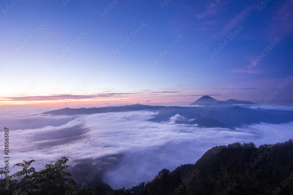 The sea of mist cover Cemoro Lawang village and Mount Bromo volcano (Gunung Bromo) during sunrise in East Java Indonesia