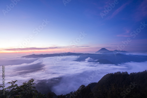 The sea of mist cover Cemoro Lawang village and Mount Bromo volcano (Gunung Bromo) during sunrise in East Java Indonesia