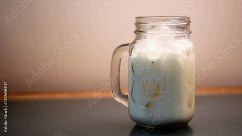 Home brewed coffee pouring into a glass of cold milk. for those early morning people and those who are satisfied by the combination of the drink mixing. photo