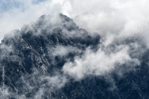 Morning mist rises above the Fairmont Ridge mountain peaks in British Columbia