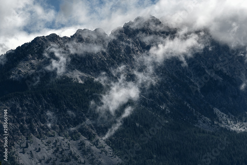 Morning mist rises above the Fairmont Ridge mountain peaks in British Columbia